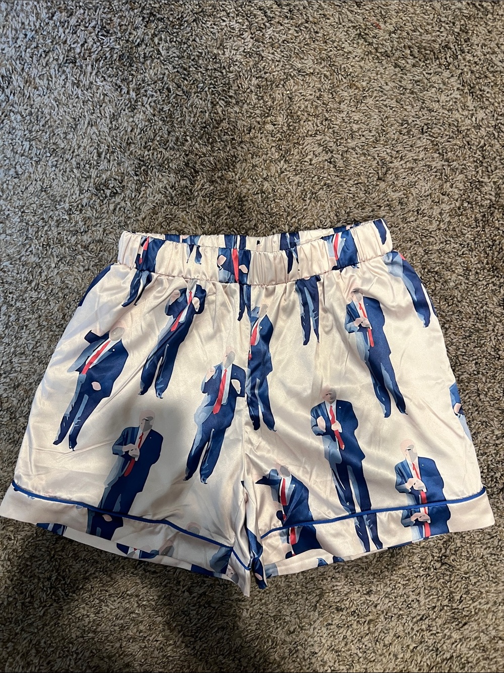 Satin shorts with Donald Trump figure print pattern